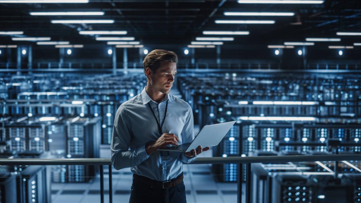 Man using laptop in warehouse