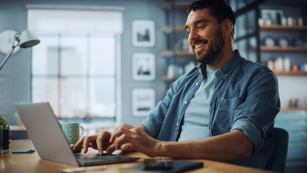 Man using laptop in home office